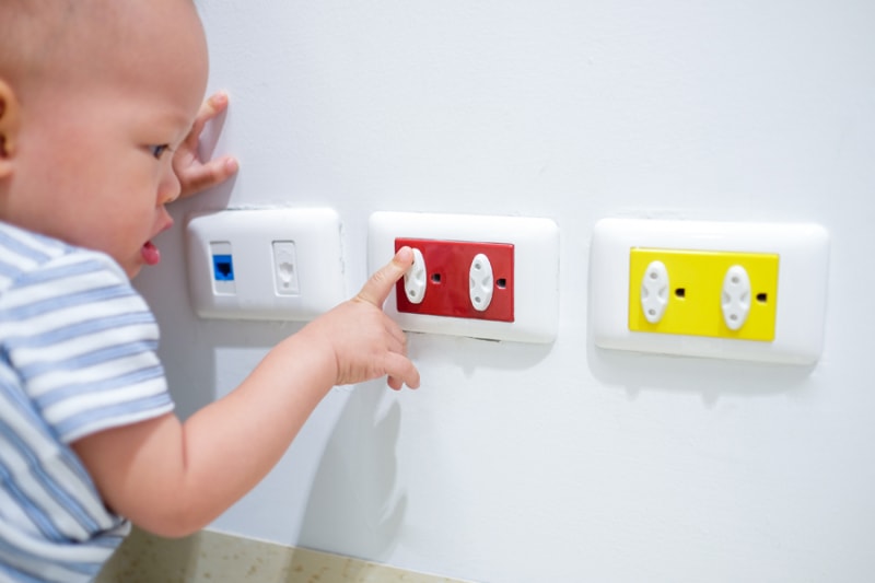 Toddler baby boy child play with electric plug.