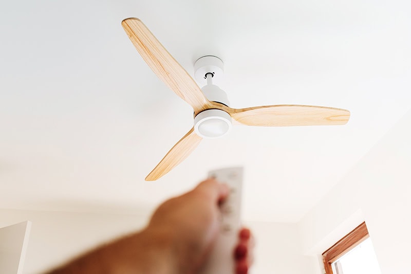 How to Choose the Right Ceiling Fan for Your Space. A remote control ceiling fan.