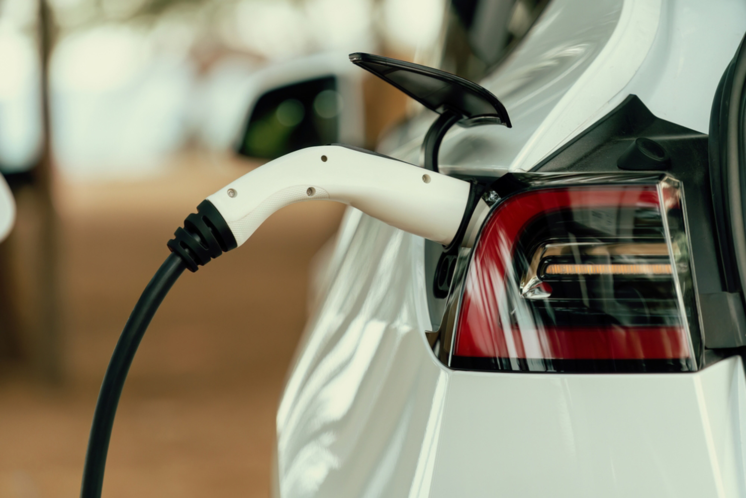 car plugged into new ev charger in garage